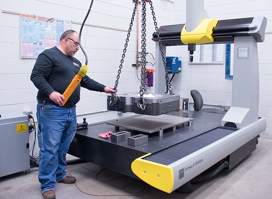 CNC Machinist working to begin the process and managing materials